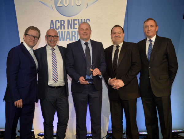 David Dunn (centre), Director and General Manager of Toshiba Air Conditioning, pictured receiving the award with the company’s Neil Hitching and David Mansell, with celebrity host Jon Culshaw (left) and Russell Beattie, Chief Executive of FETA.