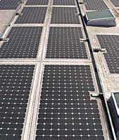 Photovoltaic solar panels are integral to a single-ply membrane roof